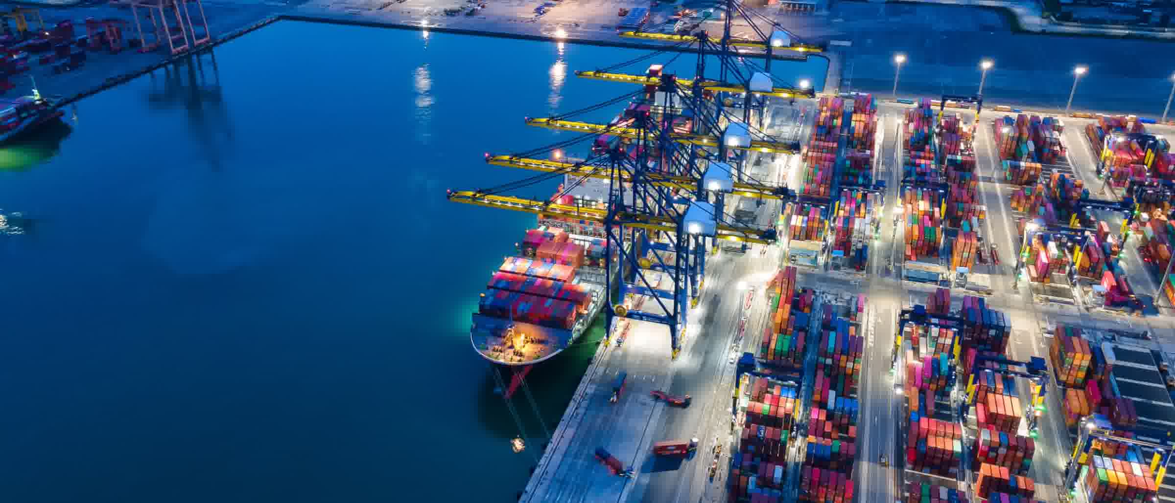 Overview of a port and terminal area with quays, cranes and storage areas